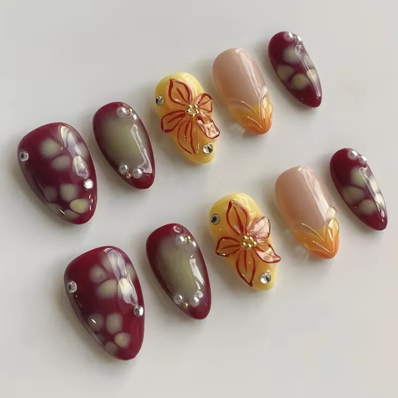 ongles amande bordeaux nude avec fleurs 3d